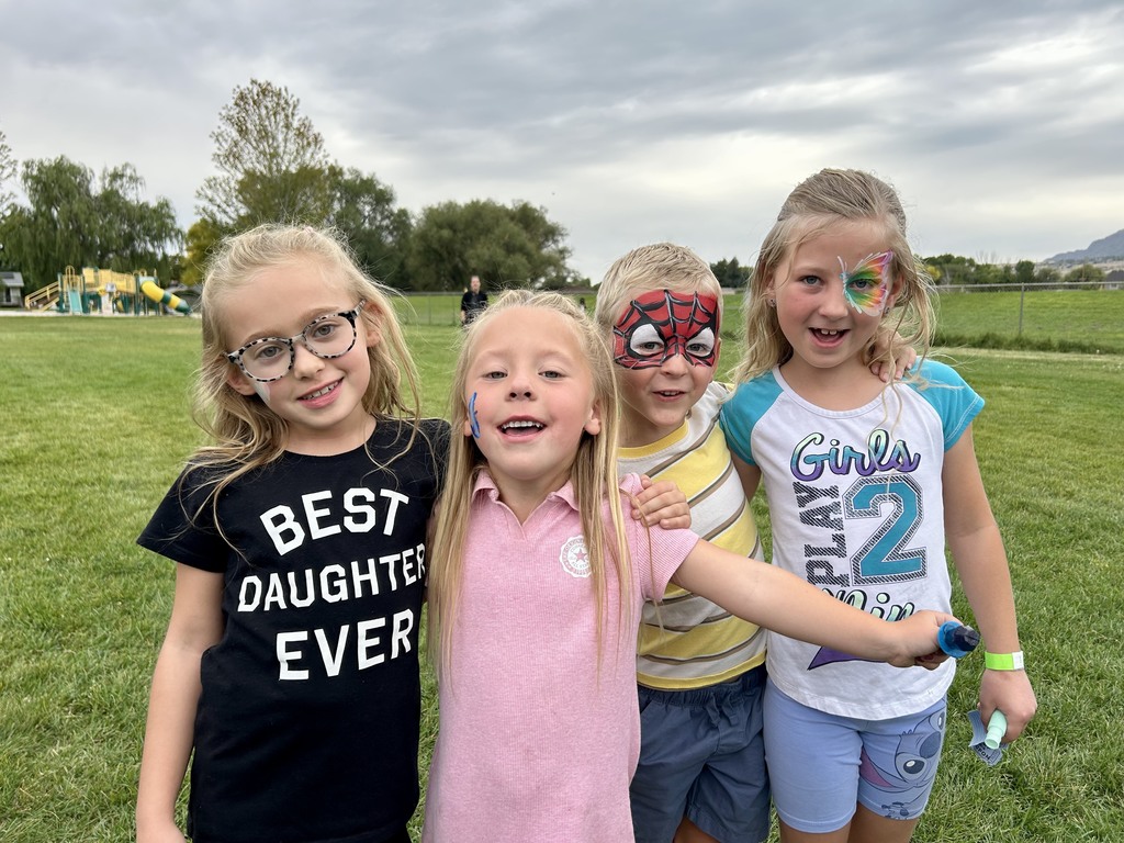 Students showing off their color face paintings