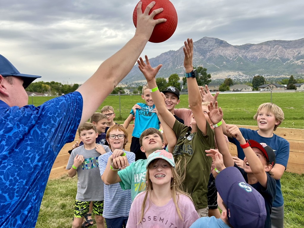Students reaching for a ball
