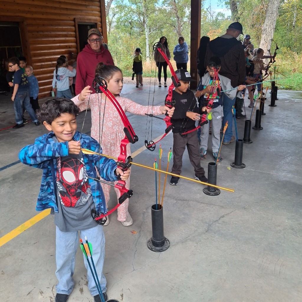 Kids shooting bows and arrows