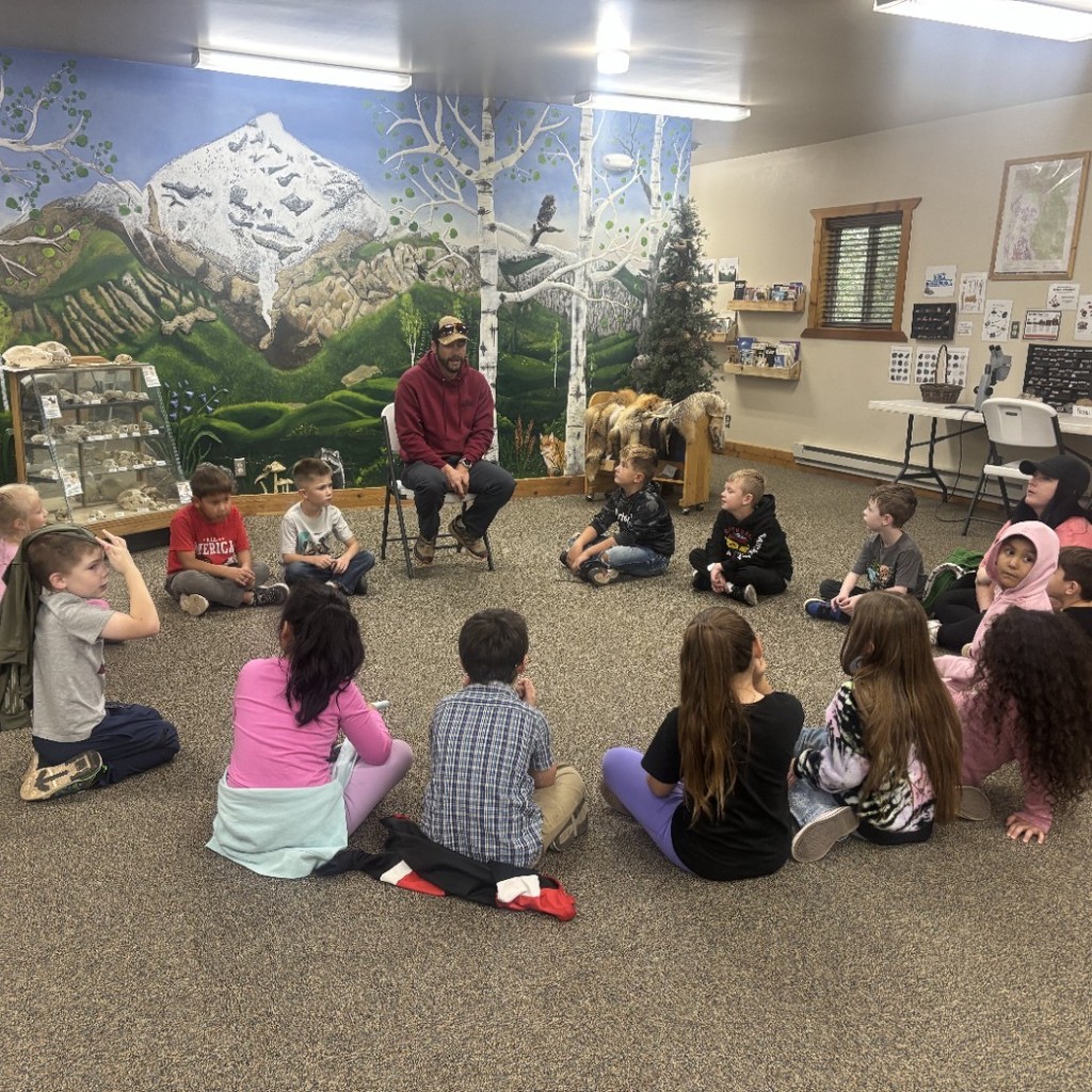 Kids sitting in a circle listening to a lesson