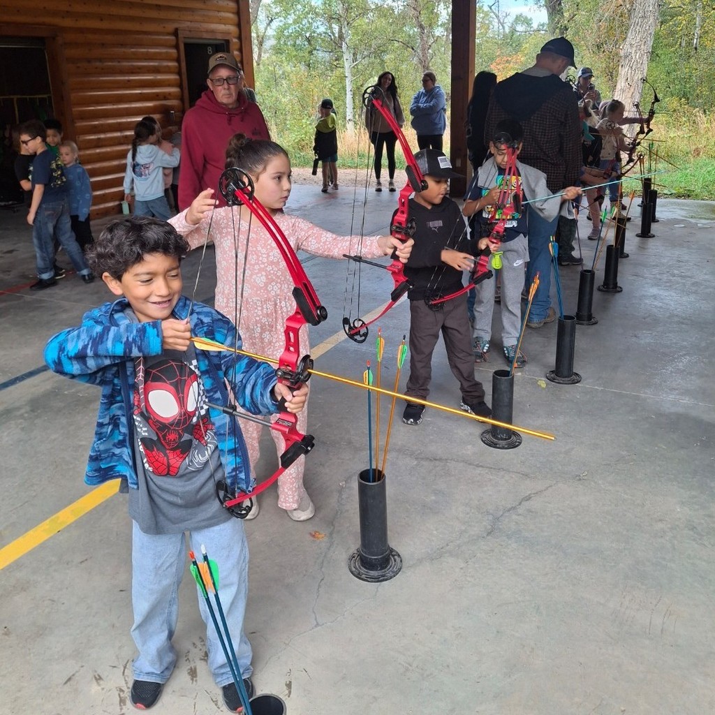 Kids shooting bows and arrows
