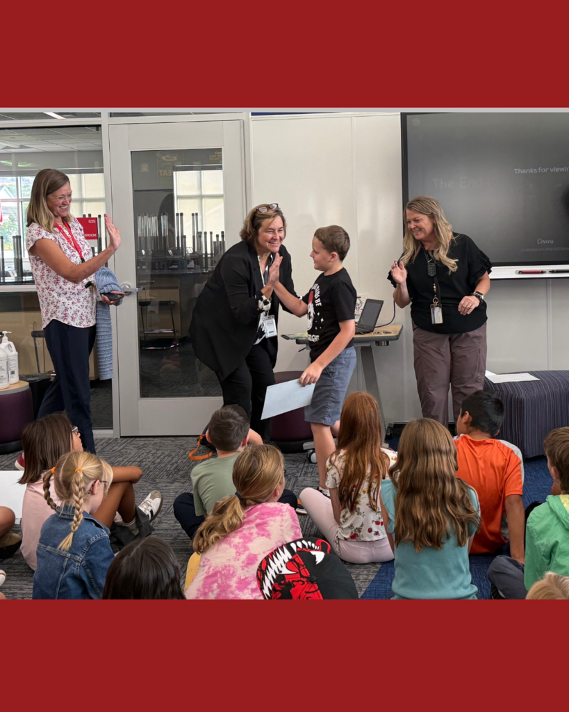 Superintendent and factulty staff congratulating students who were recognized for the Superintendent 's Summer Reading Award. 