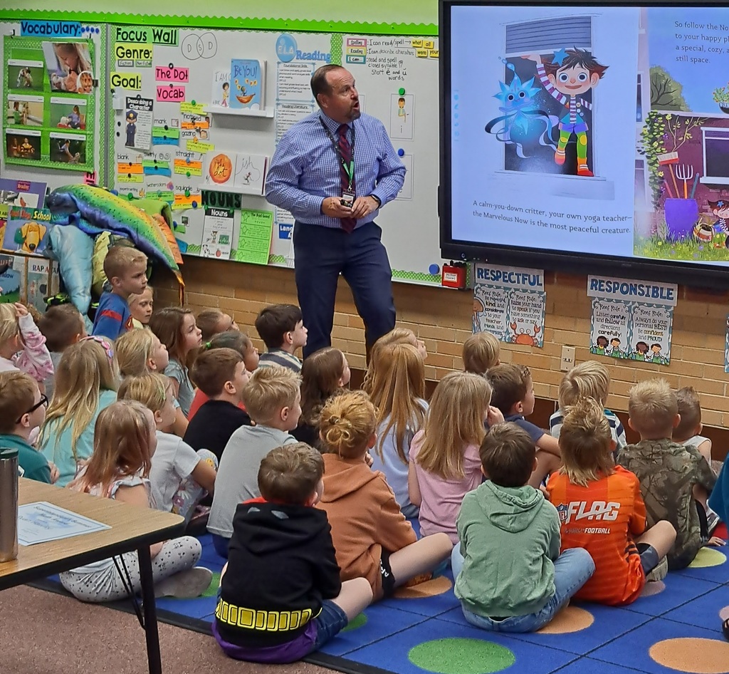"Educators presenting to elementary school students in various classroom settings, with some using interactive displays."