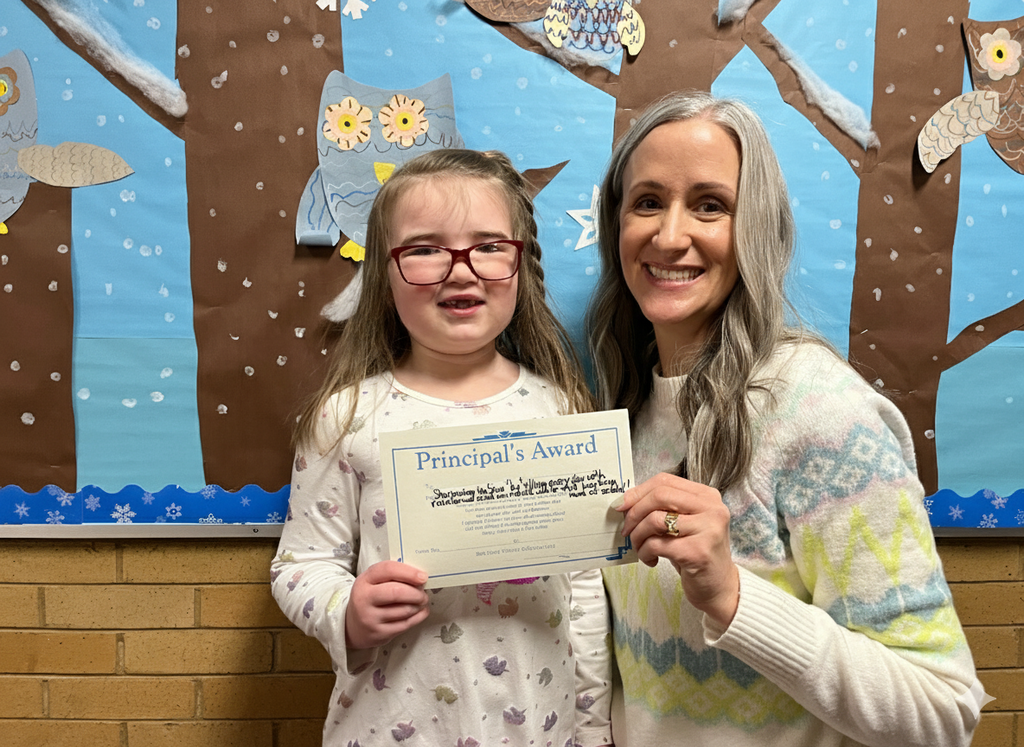 Principal giving out an award to a student