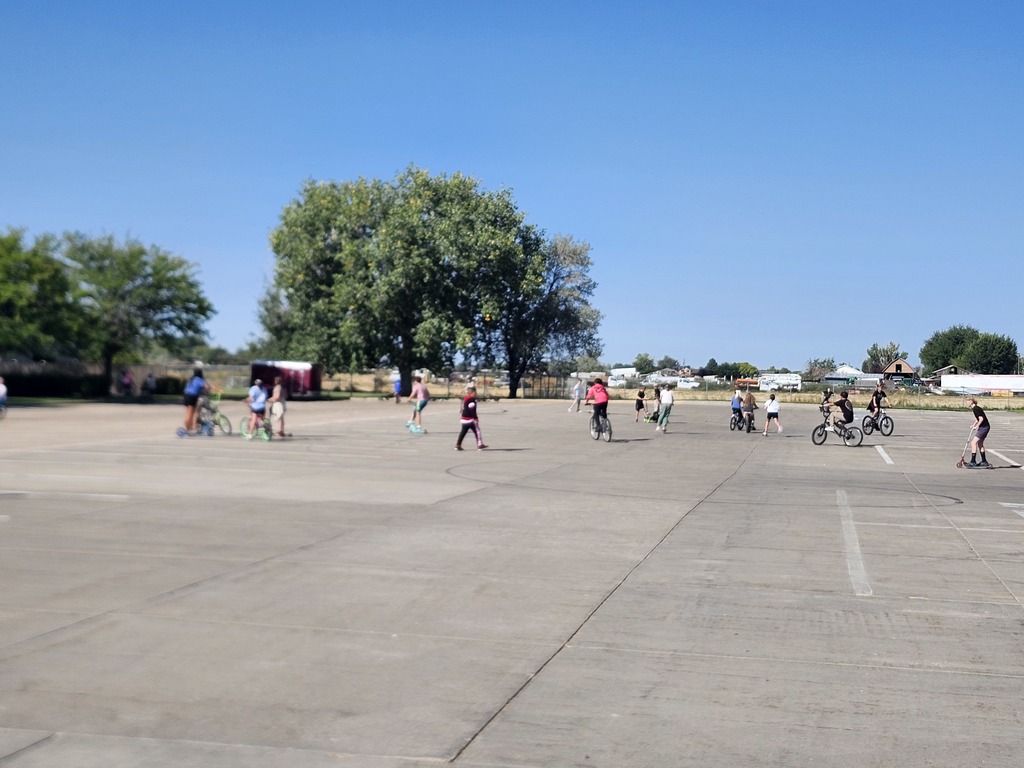 5th graders enjoying their reward, Wheels day. They brought bikes, scooters, skateboards, rollerblades and all sorts of wheels to enjoy in the church parking lot next door