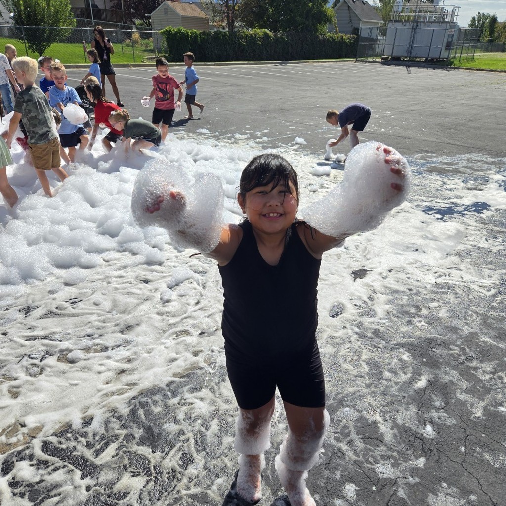 girls with suds on her arms and kids in suds