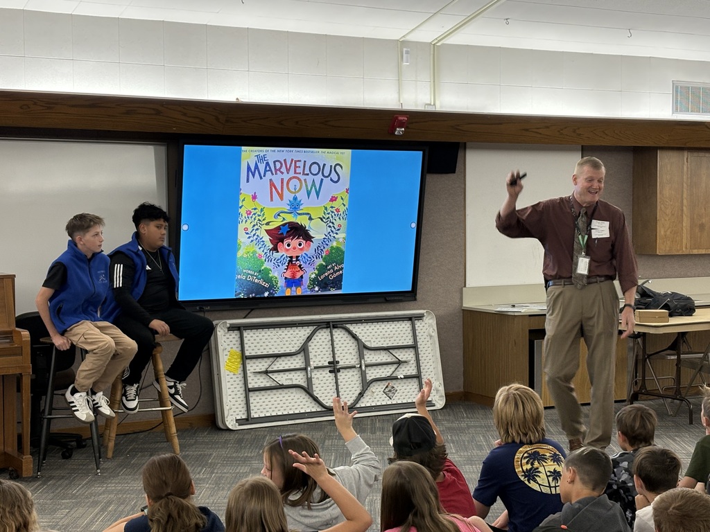 District Leader Reading to group of students