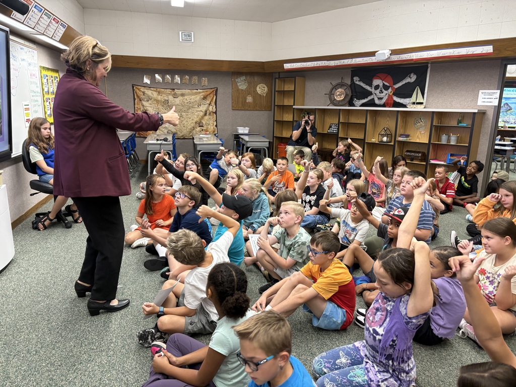 Superintendent speaks to group of students about the story that was just read