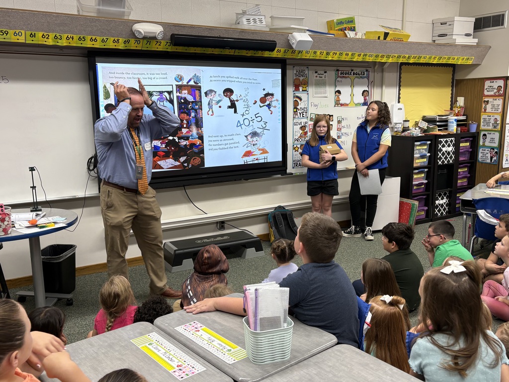 District Leader sharing a story to a group of students