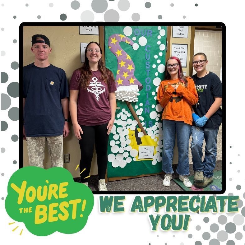 Four custodians by decorated door. You're the best! We appreciate you
