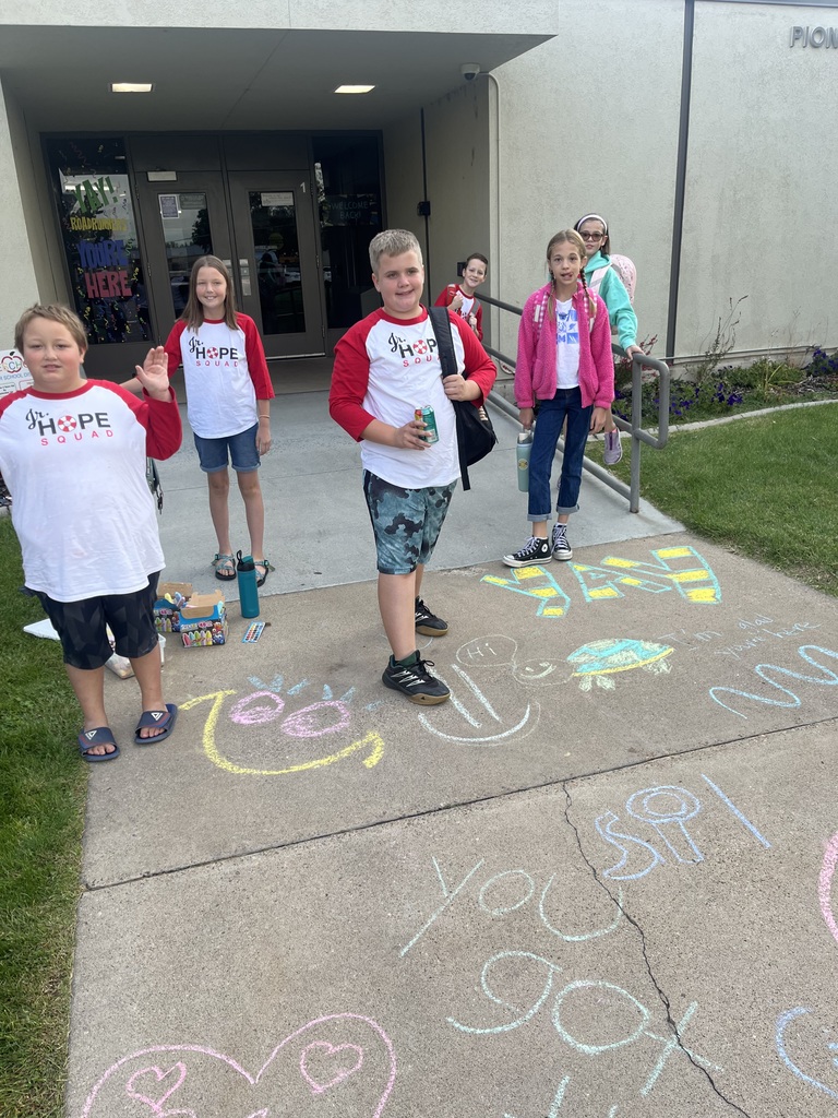 kids smiling with their chalk art