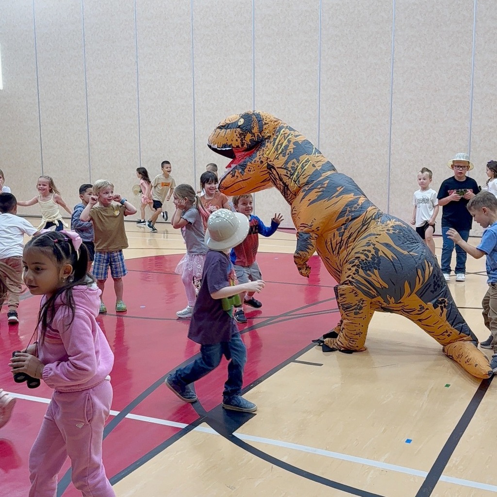 Kindergarten students participating in a dino scavenger hunt.