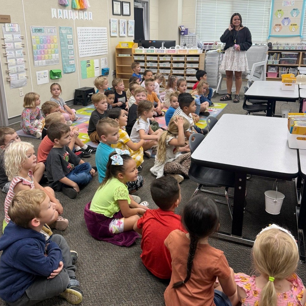 Kindergarten students participating in a dino scavenger hunt.