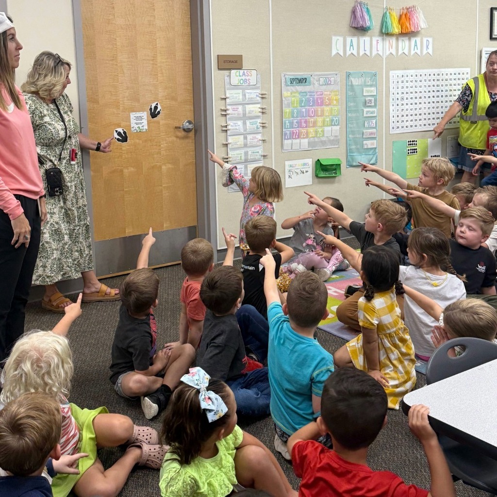 Kindergarten students participating in a dino scavenger hunt.