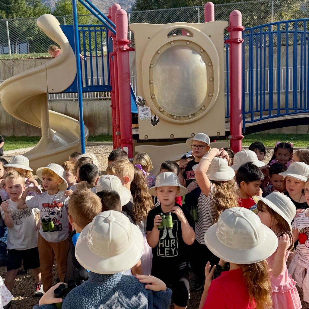 Kindergarten students participating in a dino scavenger hunt.
