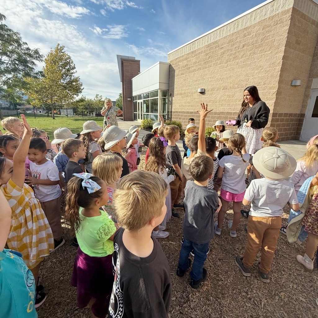 Kindergarten students participating in a dino scavenger hunt.