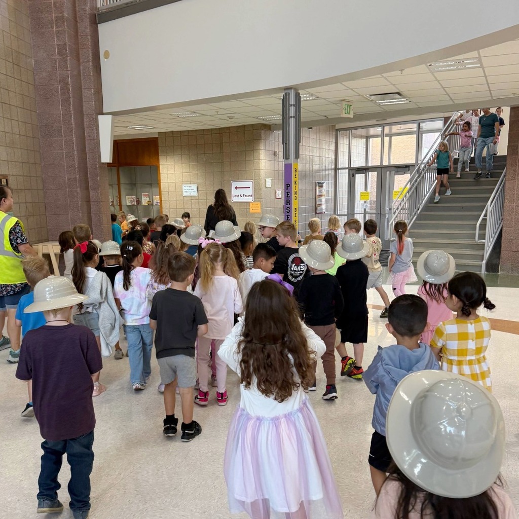 Kindergarten students participating in a dino scavenger hunt.