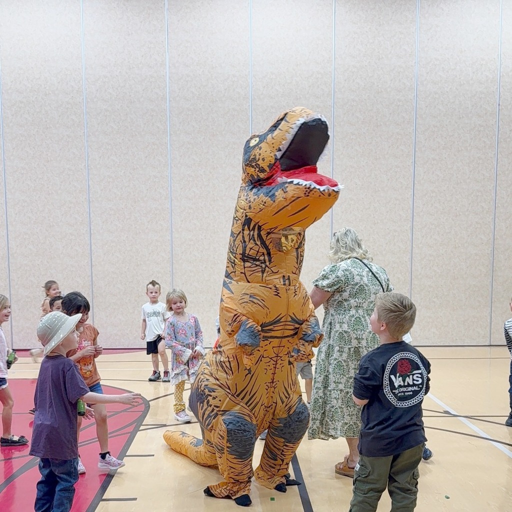 Kindergarten students participating in a dino scavenger hunt.