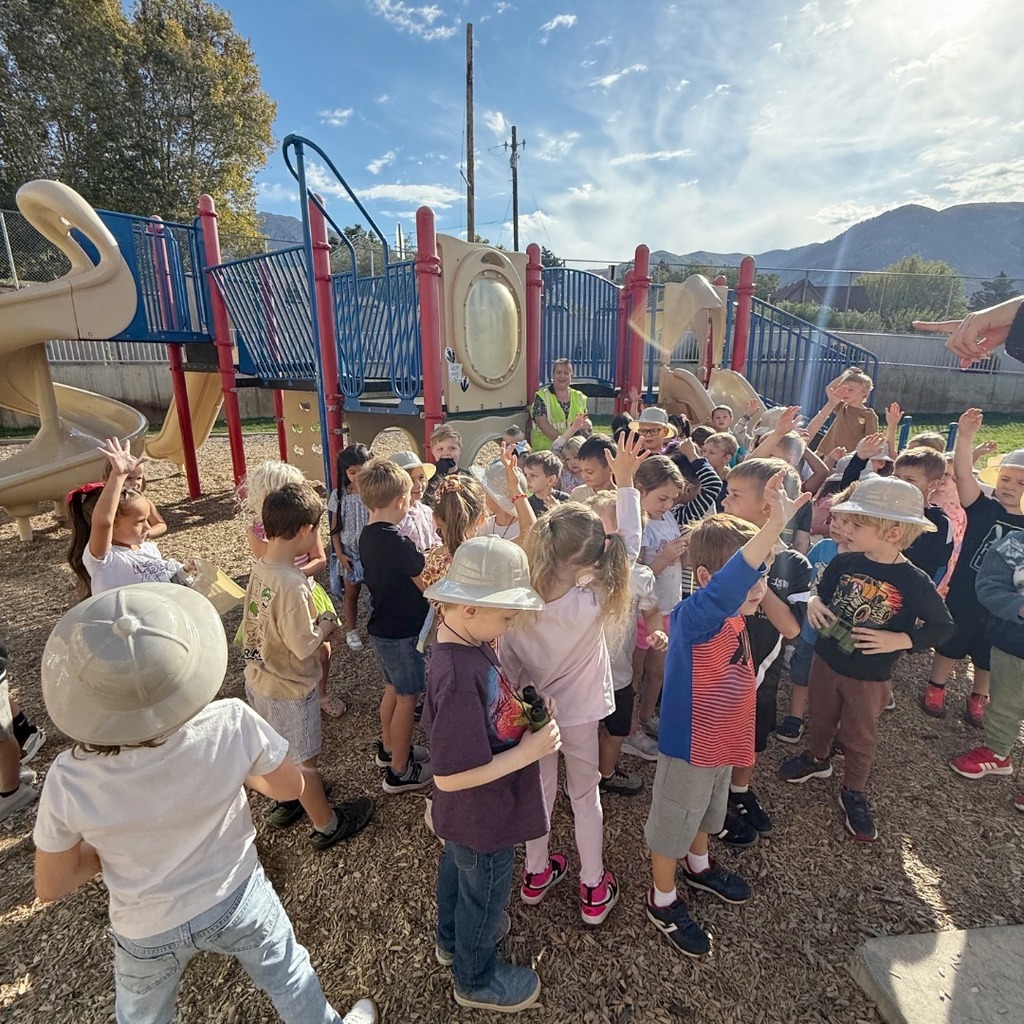 Kindergarten students participating in a dino scavenger hunt.