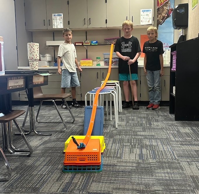Students by a hot wheels track