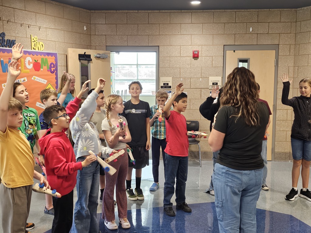 Students engaged with an instructor raising their hands to participate with Starbase. 