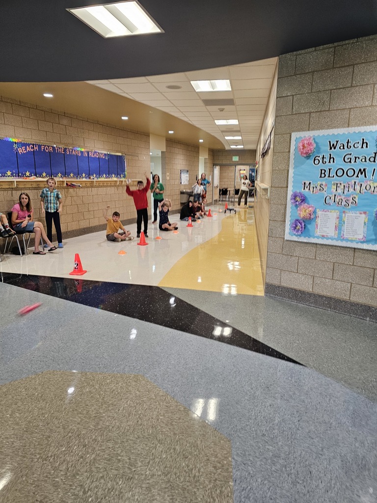Students racing Starbase cars they created after school. 