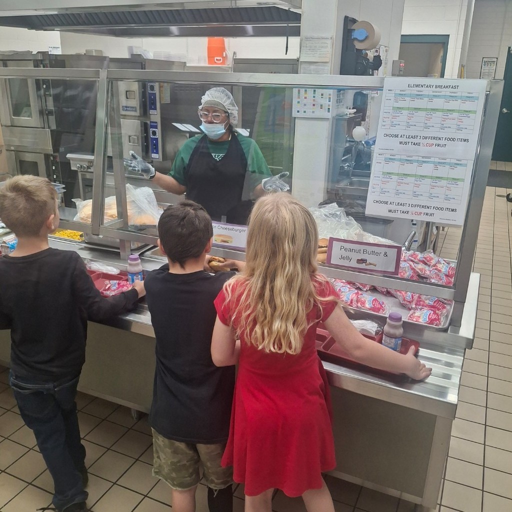 Risa serving lunch to kids