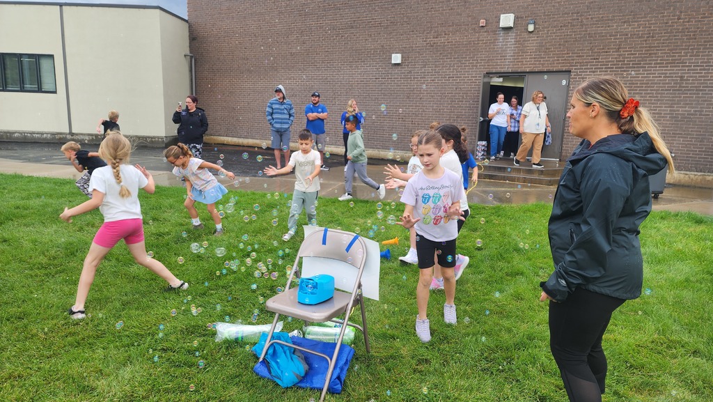 Students playing in bubbles