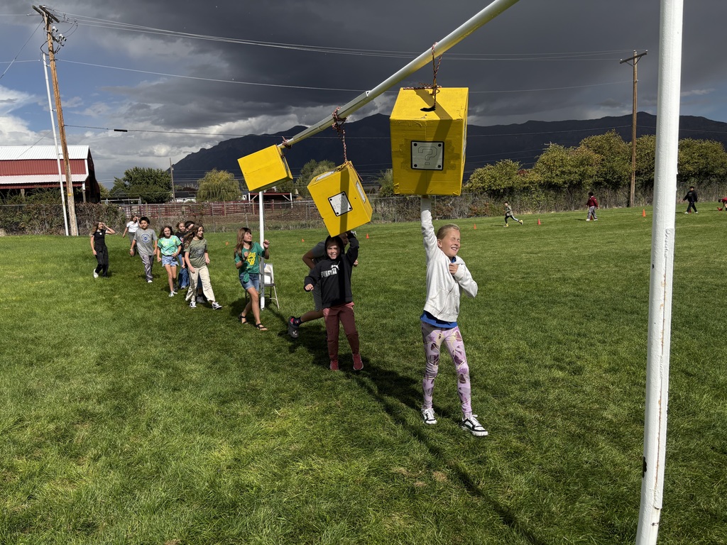 Students running and jumping in fun run obstacle course