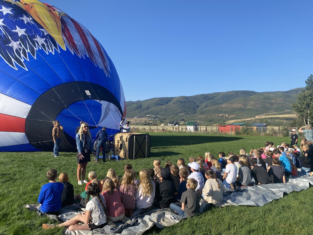 Image of students and teachers with hot air balloon.