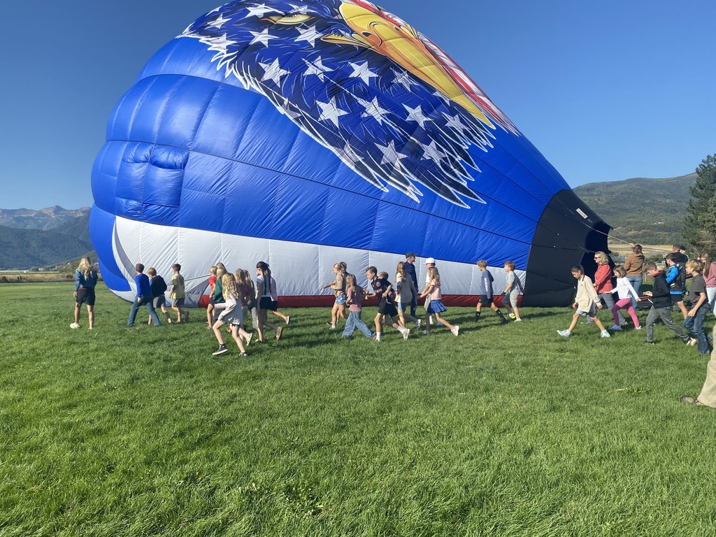 Image of students and teachers with hot air balloon.