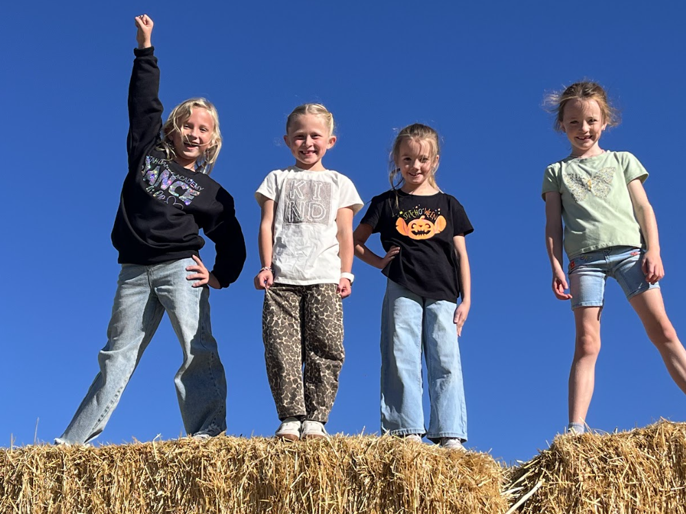Kids on hay bale