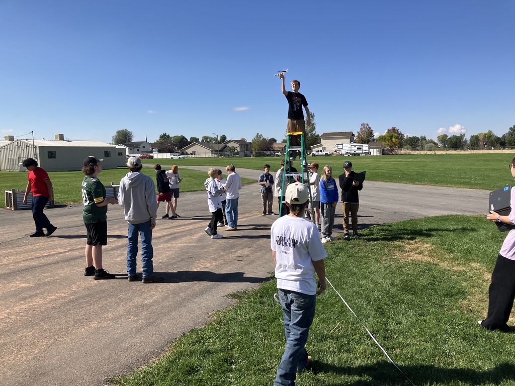 Students spent over a week trying to build a successful rubber-band powered glider that could fly 50ft. As we finished up the unit on Heavier-than-Air travel. In the unit, they were learning about the forces and breakthroughs humankind had to make for this kind of flight to be possible. This is what flight day looked like as they gathered their data.