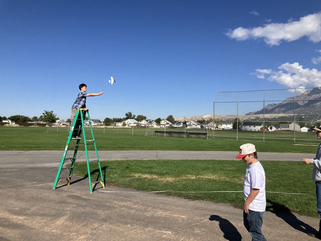 Students spent over a week trying to build a successful rubber-band powered glider that could fly 50ft. As we finished up the unit on Heavier-than-Air travel. In the unit, they were learning about the forces and breakthroughs humankind had to make for this kind of flight to be possible. This is what flight day looked like as they gathered their data.
