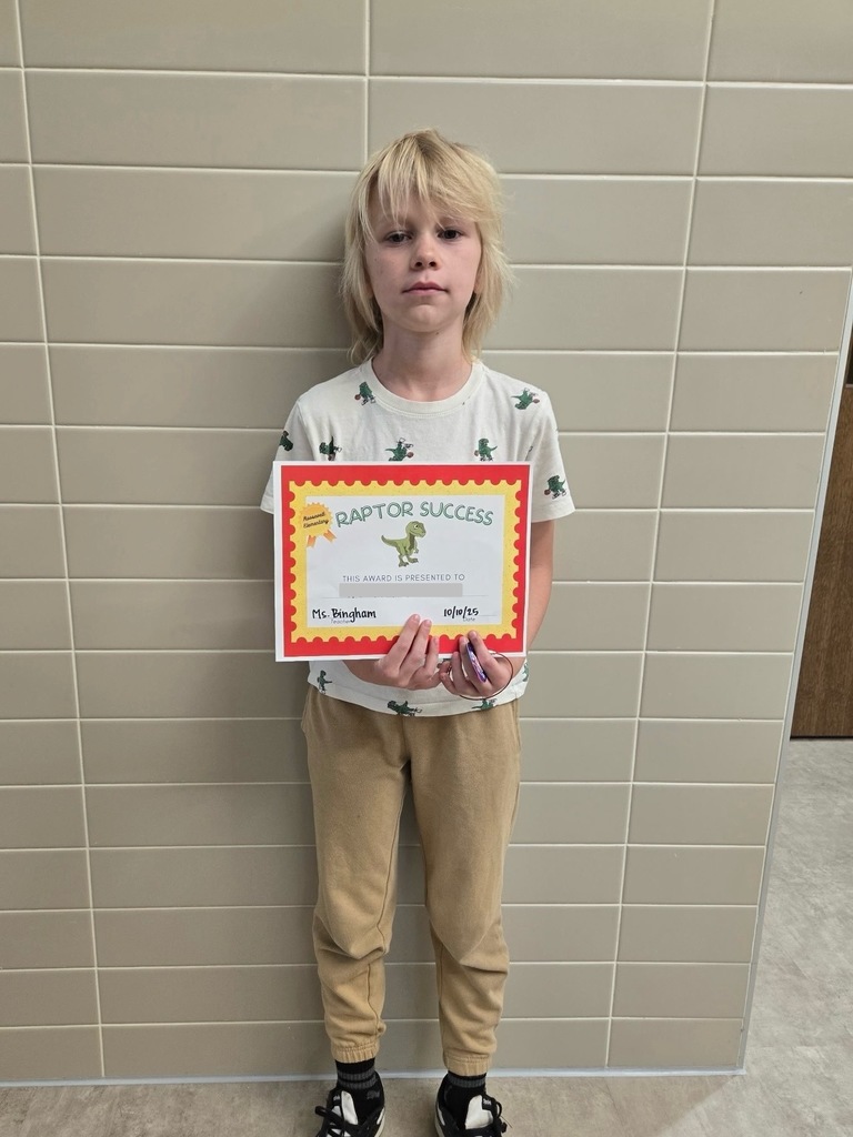 1 students standing with their raptor success award