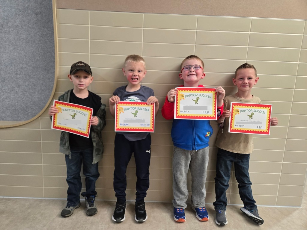 4 students standing with their raptor success awards