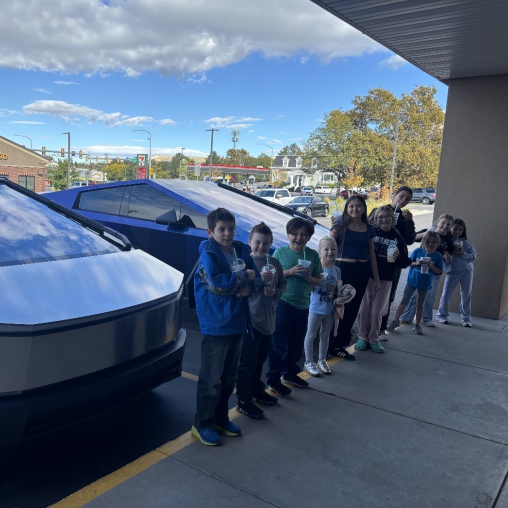 Kids in front of Teslas
