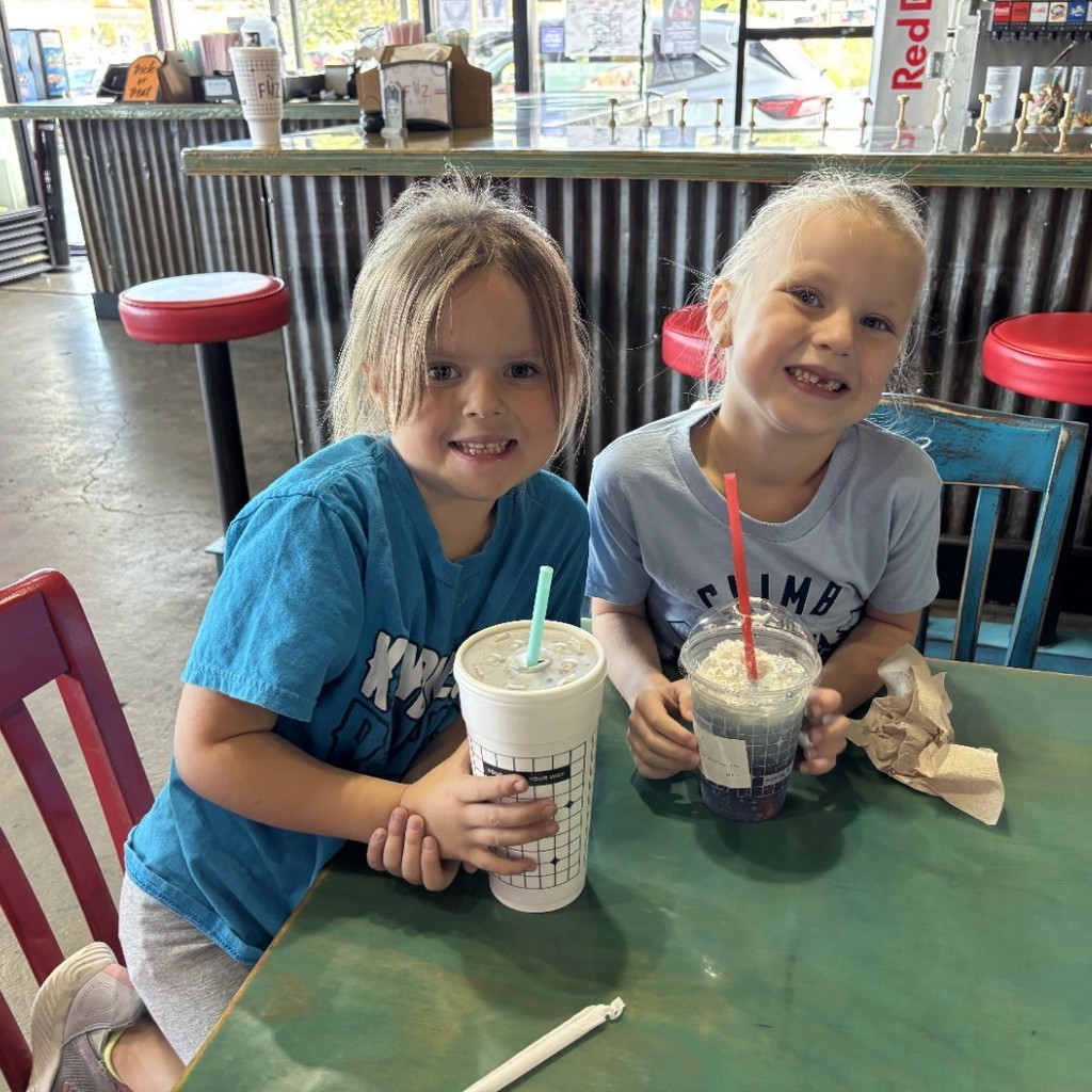 two girls enjoying a soda at Fiz
