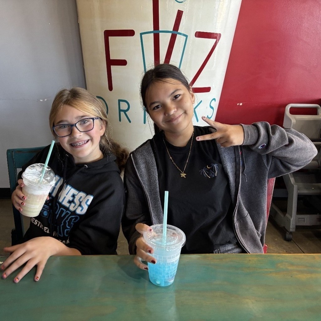two girls enjoying a soda at Fiz