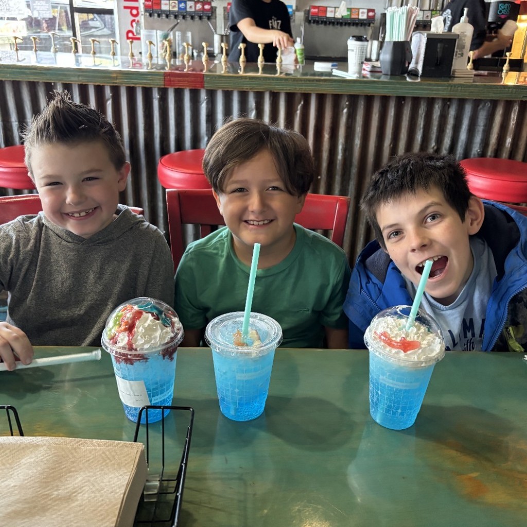 three boys enjoying drinks at Fiz