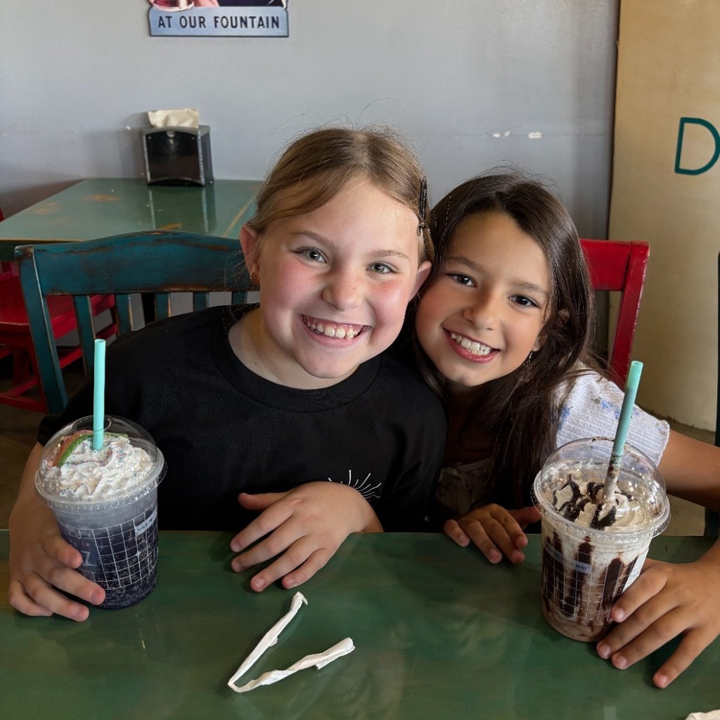 two girls enjoying drinks at Fiz