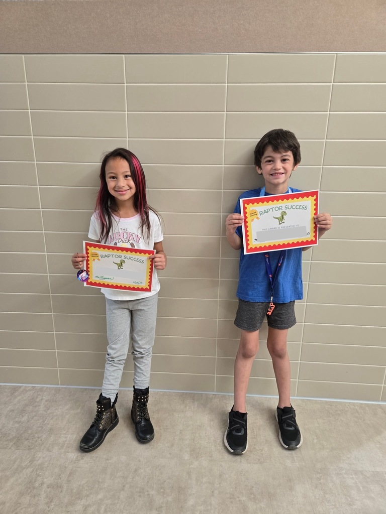 Students standing and holding an awards
