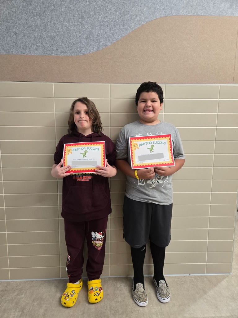 Students standing and holding an awards