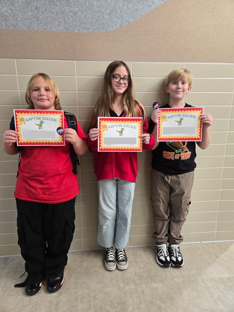 Students standing and holding an awards