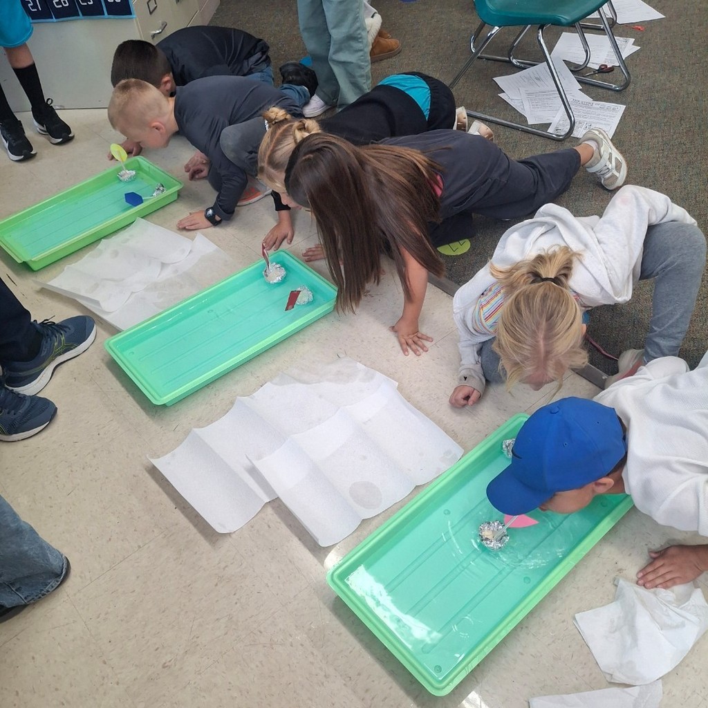 Kids racing/blowing their boats