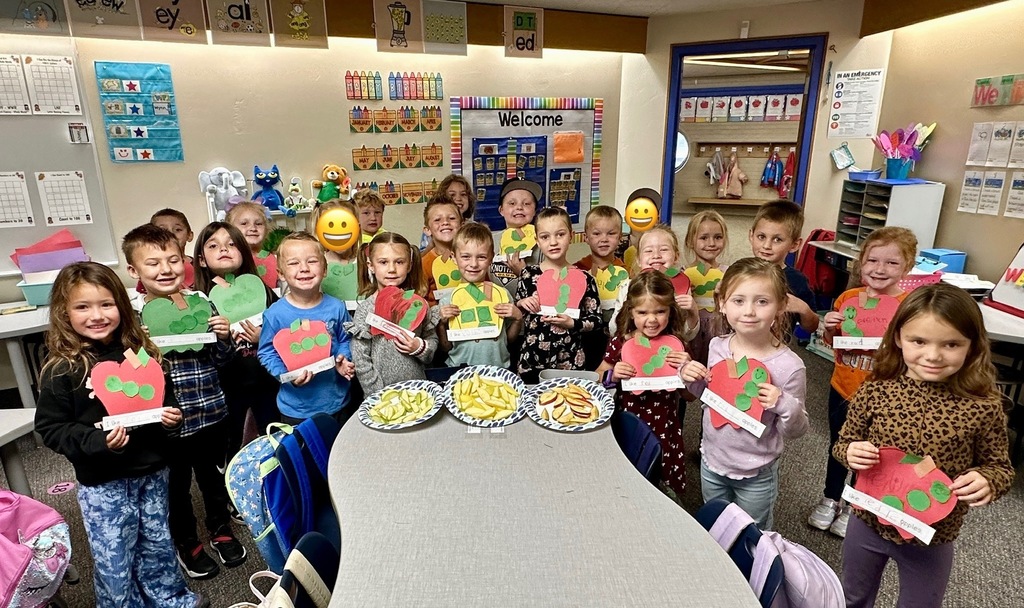 kinder students with apple art