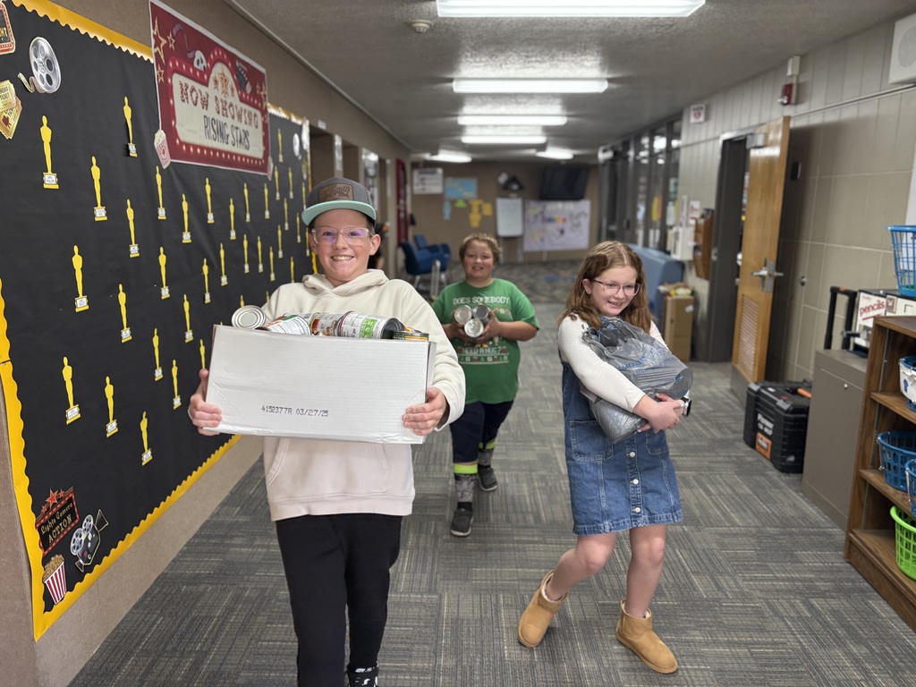 Students carrying food for our food drive