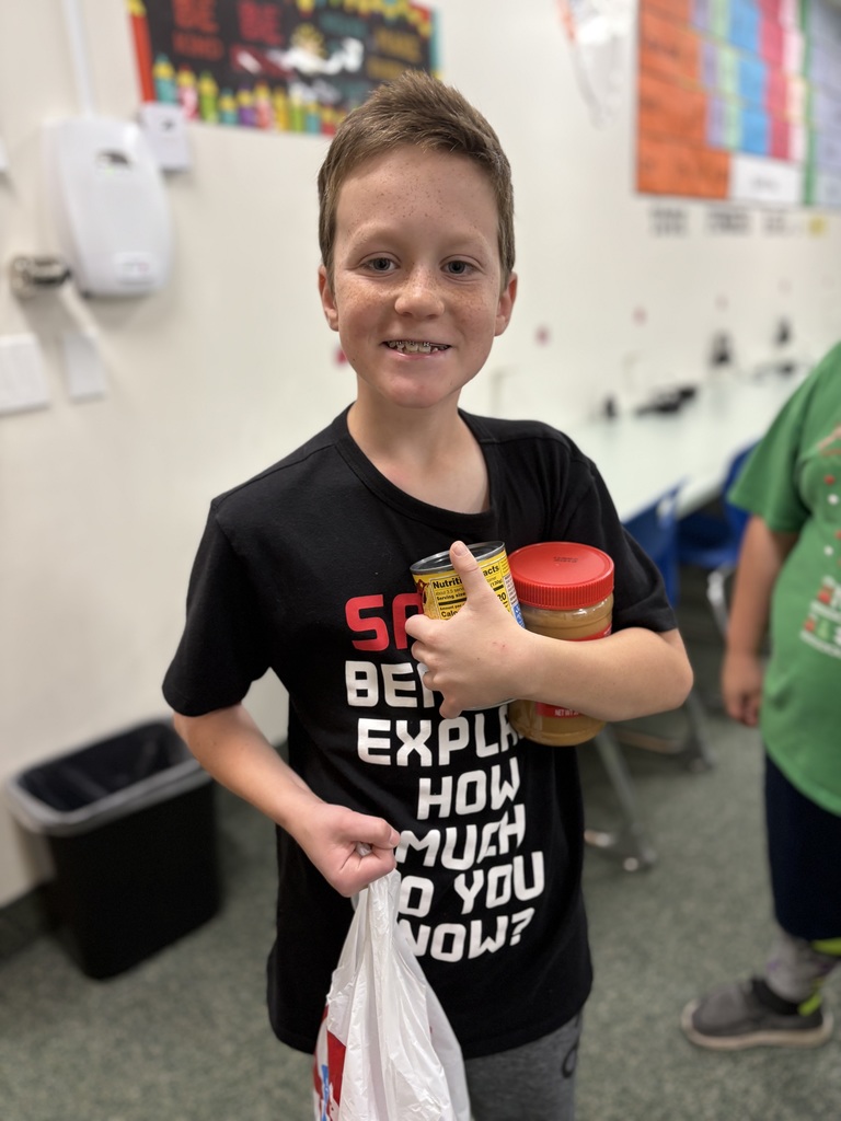 Student carrying food for food drive