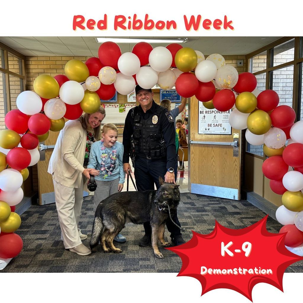 Red ribbon week K-9 demonstration. teacher & student by police officer & dog