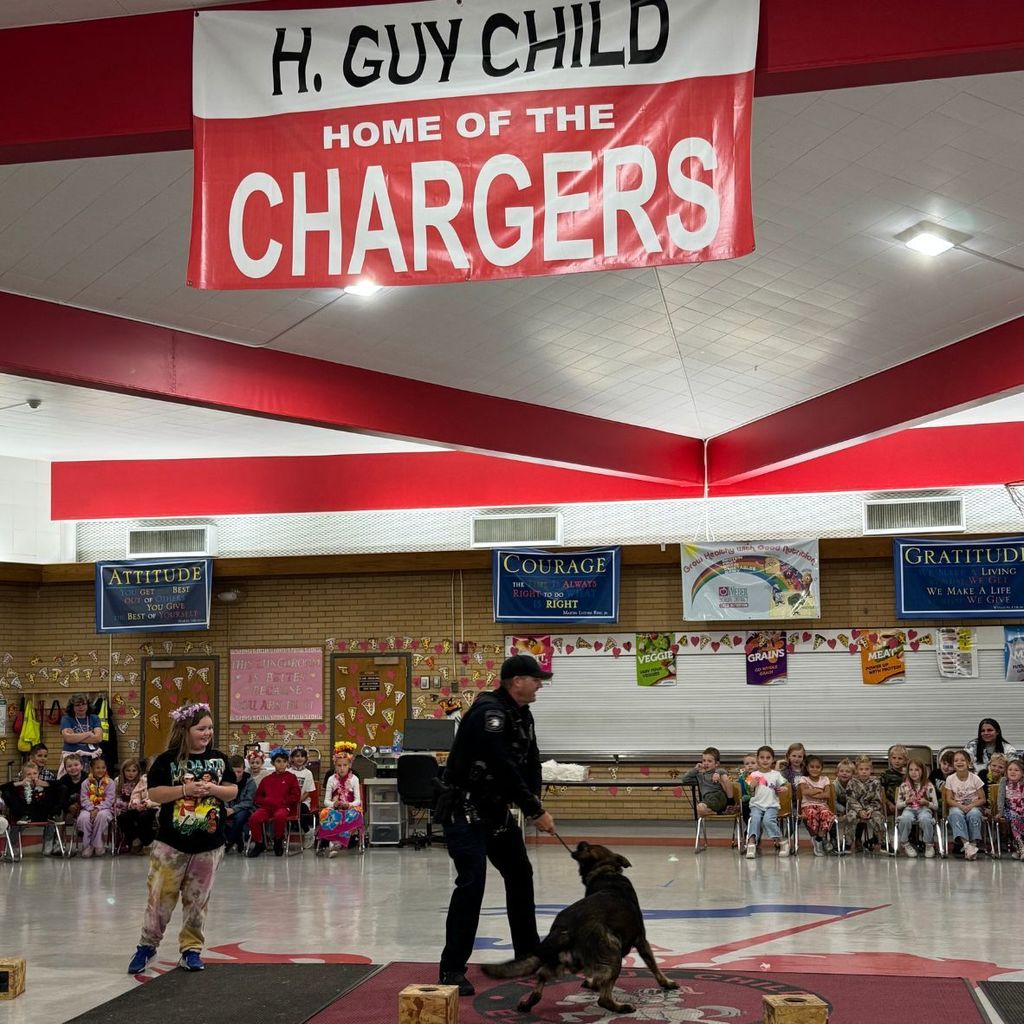 H Guy Child Home of the Chargers. Police officer & dog giving a demonstration of drug smell identification to a student assembly